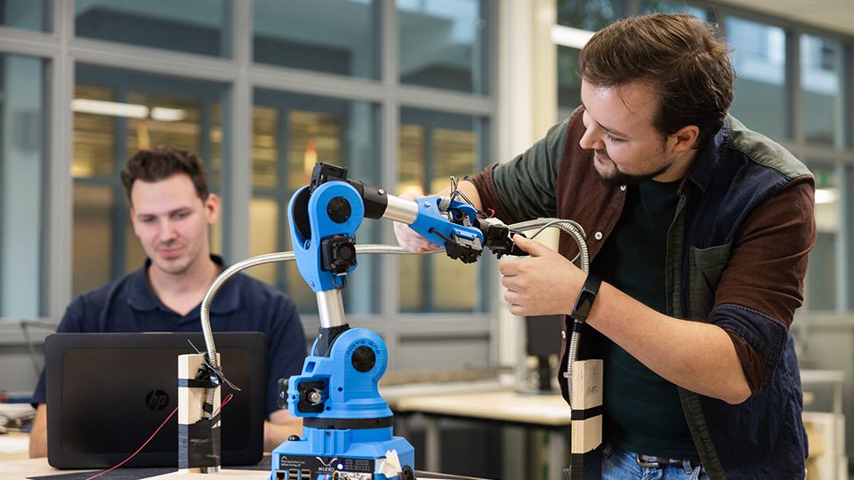 engineer working on robot arm